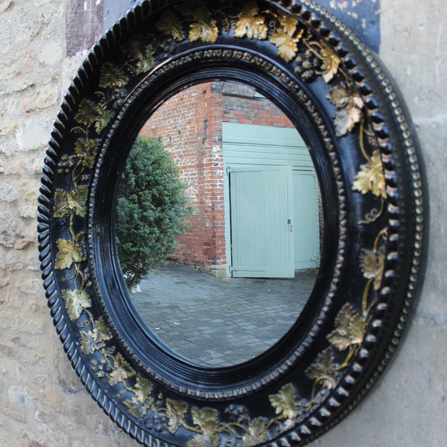 A Large Black & Gilt Circular Wall Mirror