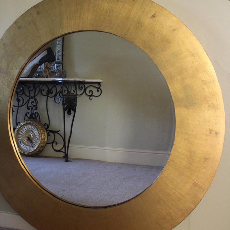A Very Large Gilded Circular Wall Mirror