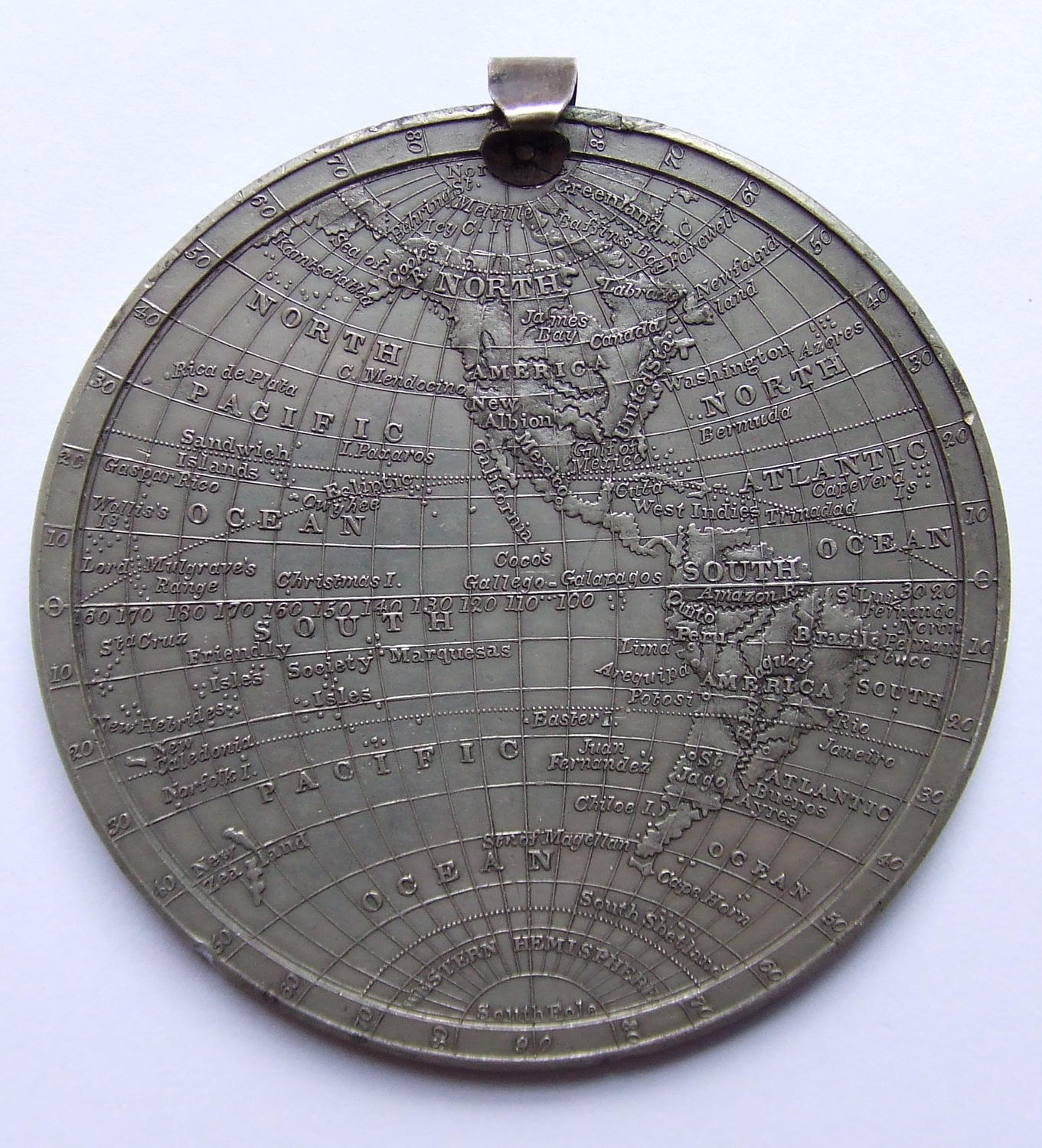 An Antique `Map of the World` White Metal Medallion