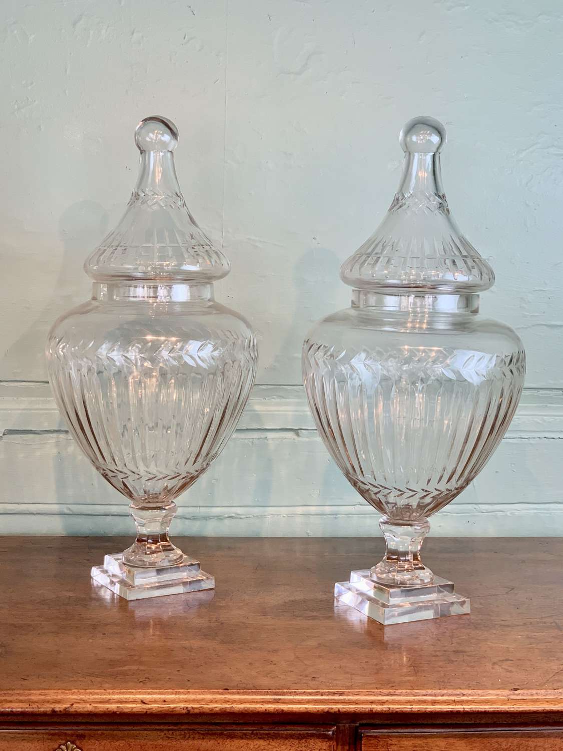 A Large Pair of Cut Glass Shop Display Jars & Covers
