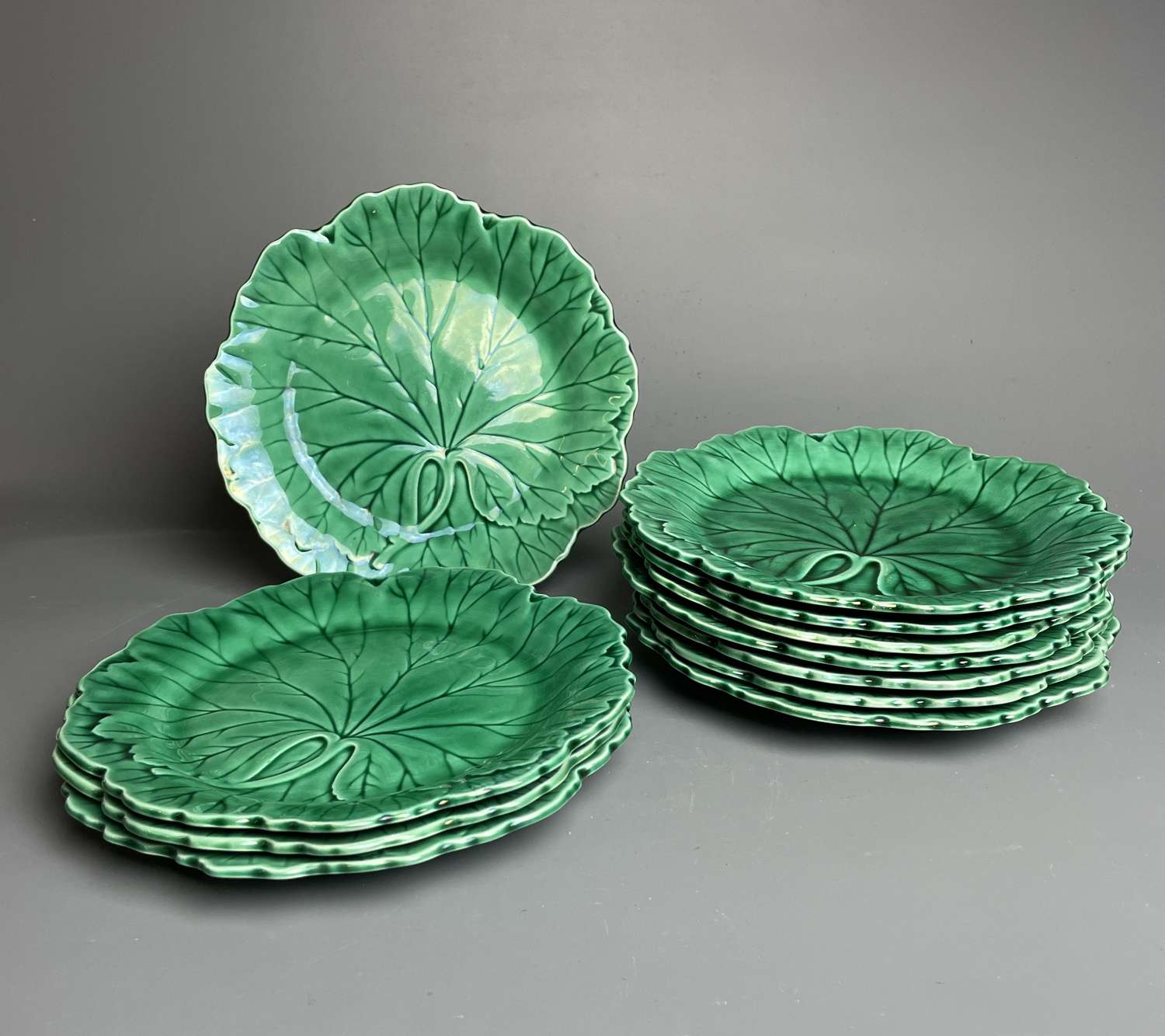 Eleven Wedgwood Green Glazed Cabbageware Plates